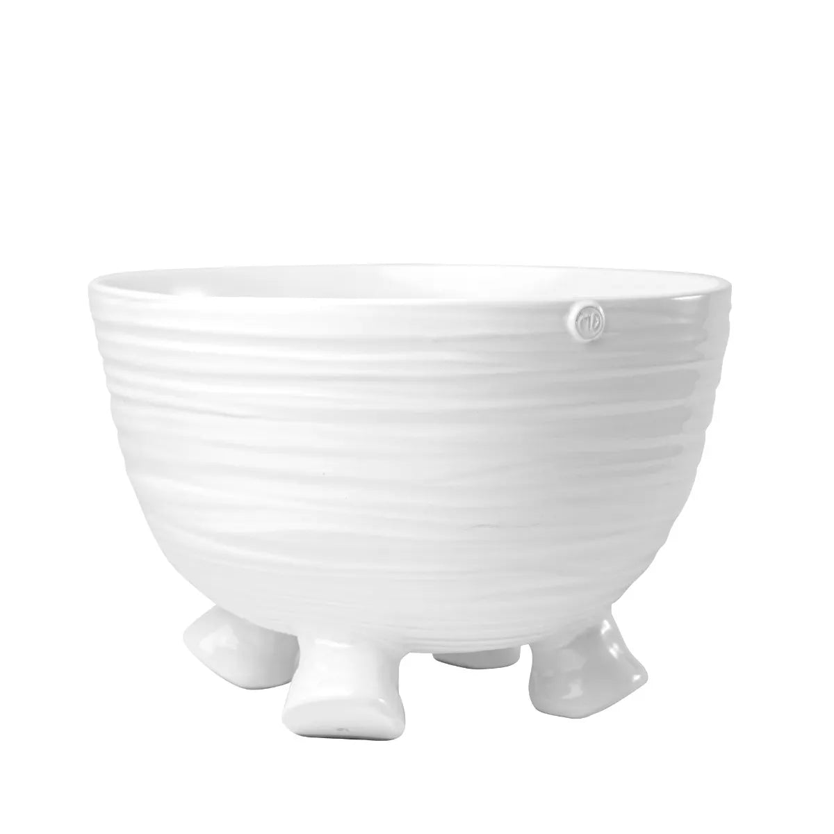 A white, handmade ceramic bowl with a creamy finish and unique base design, part of a serveware collection.