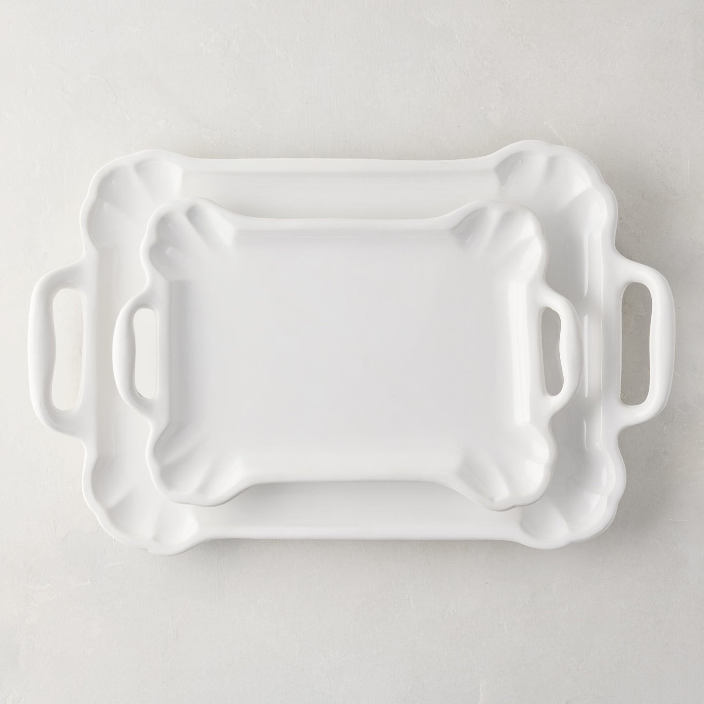 Set of 2 Alessia vintage-inspired creamy white ceramic serving platters, small and large, with handles.