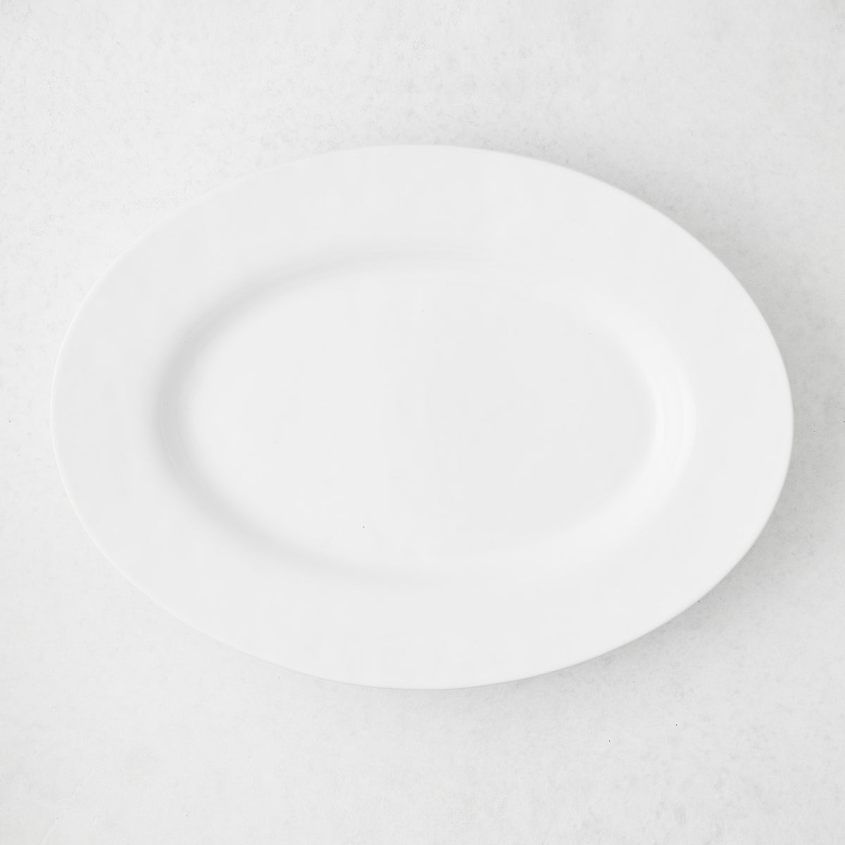 Artisan Stoneware Serve Platter, creamy white oval stoneware platter with a wide lip.