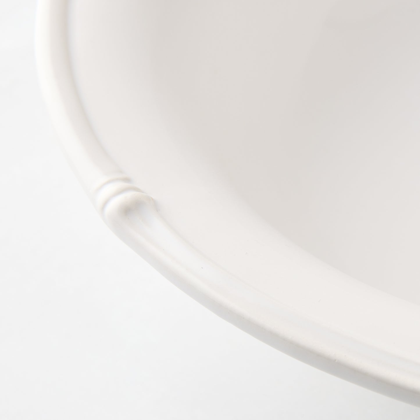White ceramic serve bowl with molded bamboo detailing.