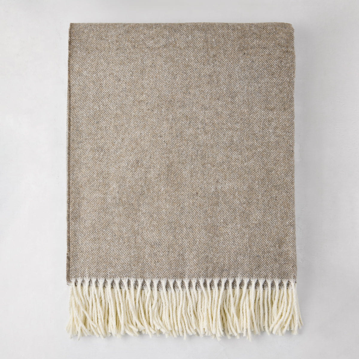 Barnwood Italian Herringbone Throw Blanket, cashmere-soft cotton-acrylic, with decorative fringe.