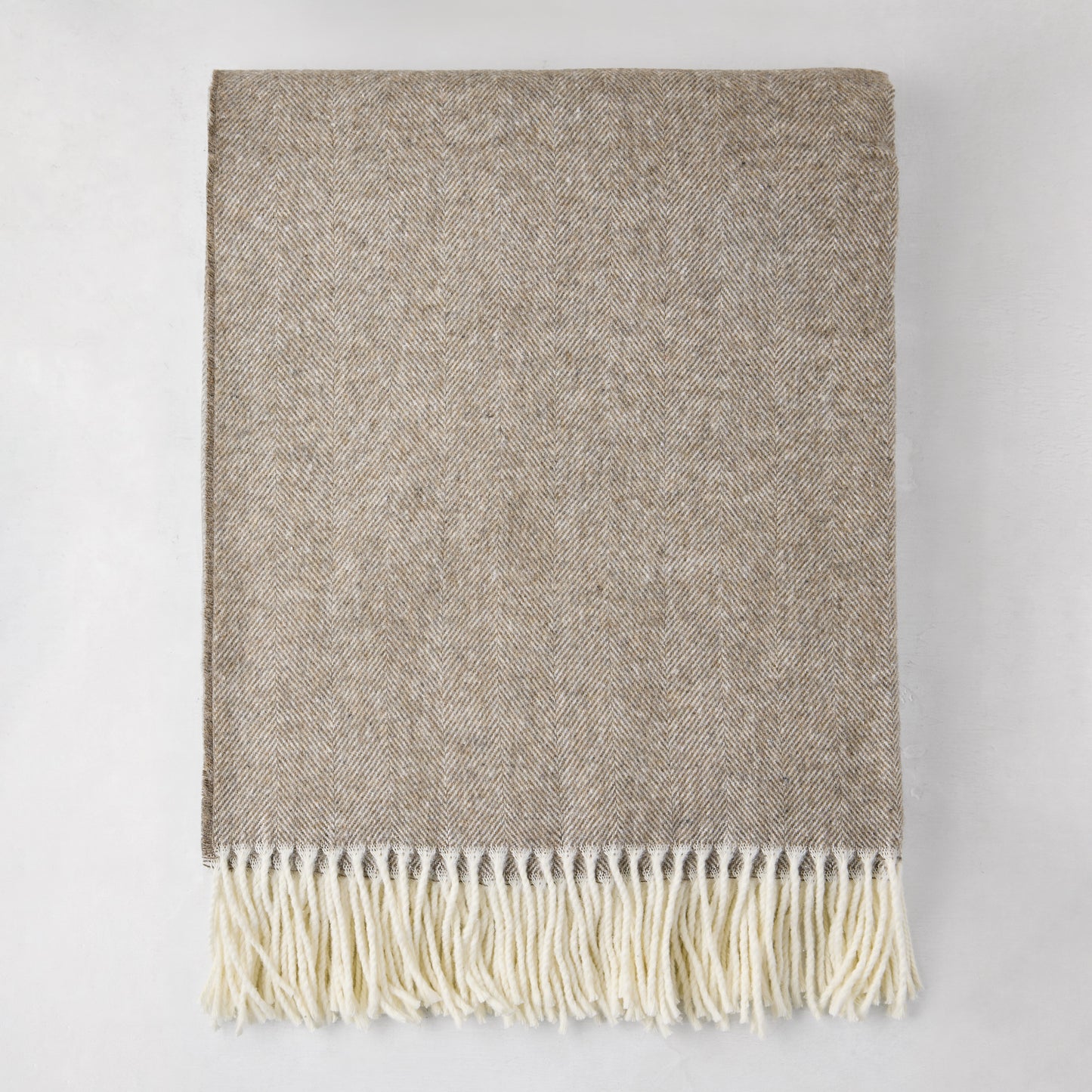 Barnwood Italian Herringbone Throw Blanket, cashmere-soft cotton-acrylic, with decorative fringe.