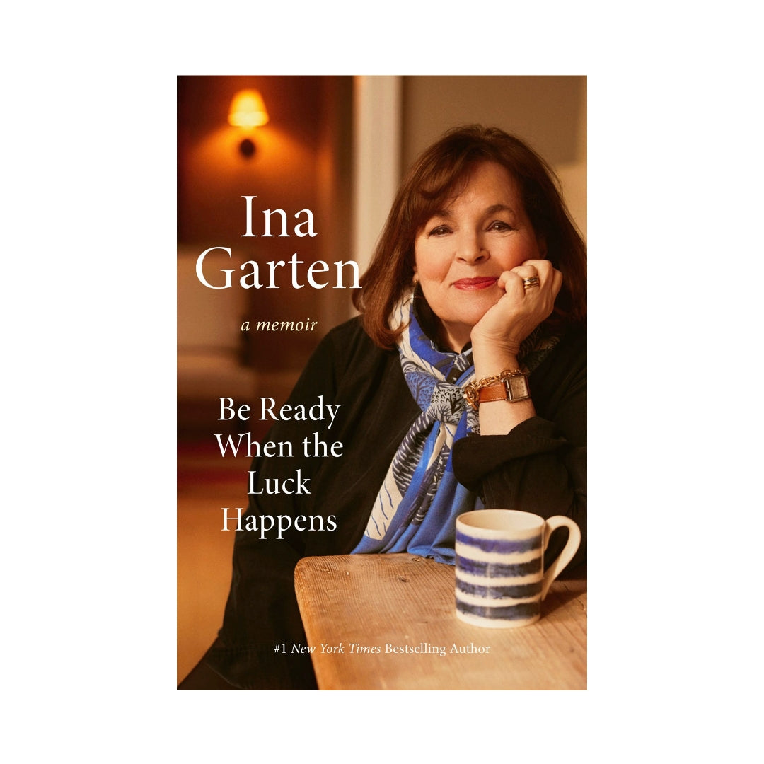 Hardcover book, "Be Ready When Luck Happens" by Ina Garten, featuring her portrait and a striped mug.