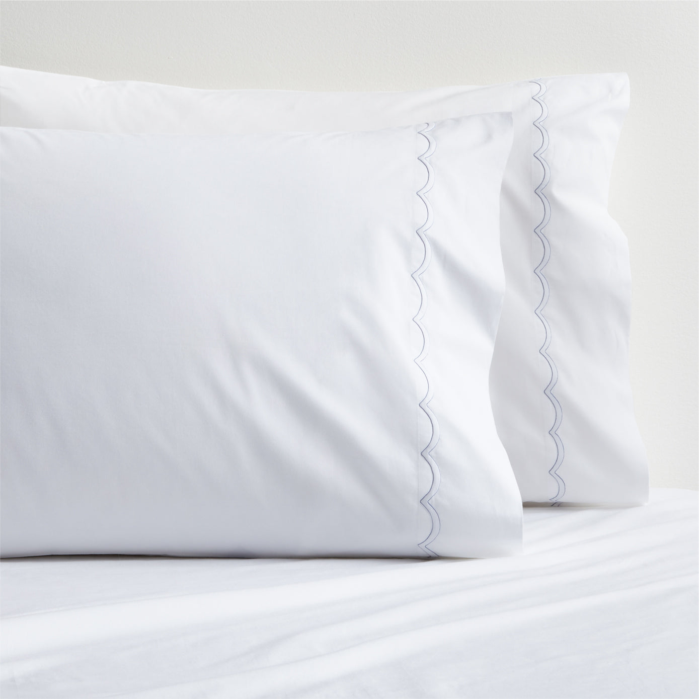 White percale pillowcases with blue scallop stitching, set of 2.