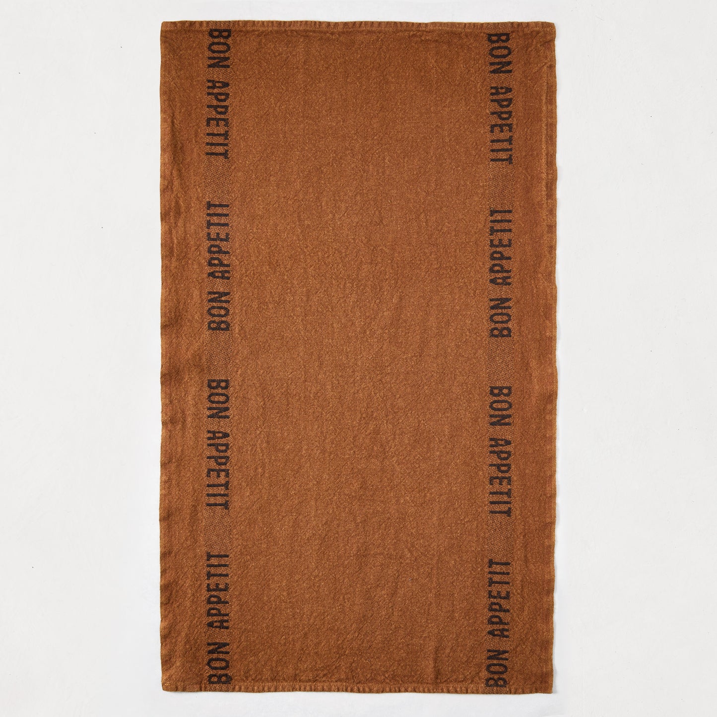 Brown linen hand towel with "BON APPETIT" printed vertically in black on both sides.