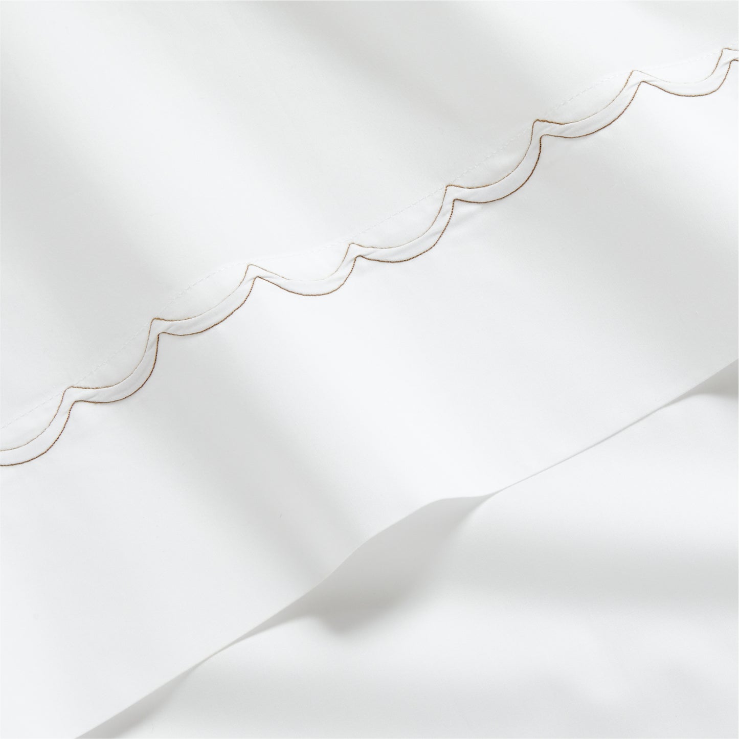 White percale sheet with brown scallop stitch edging.