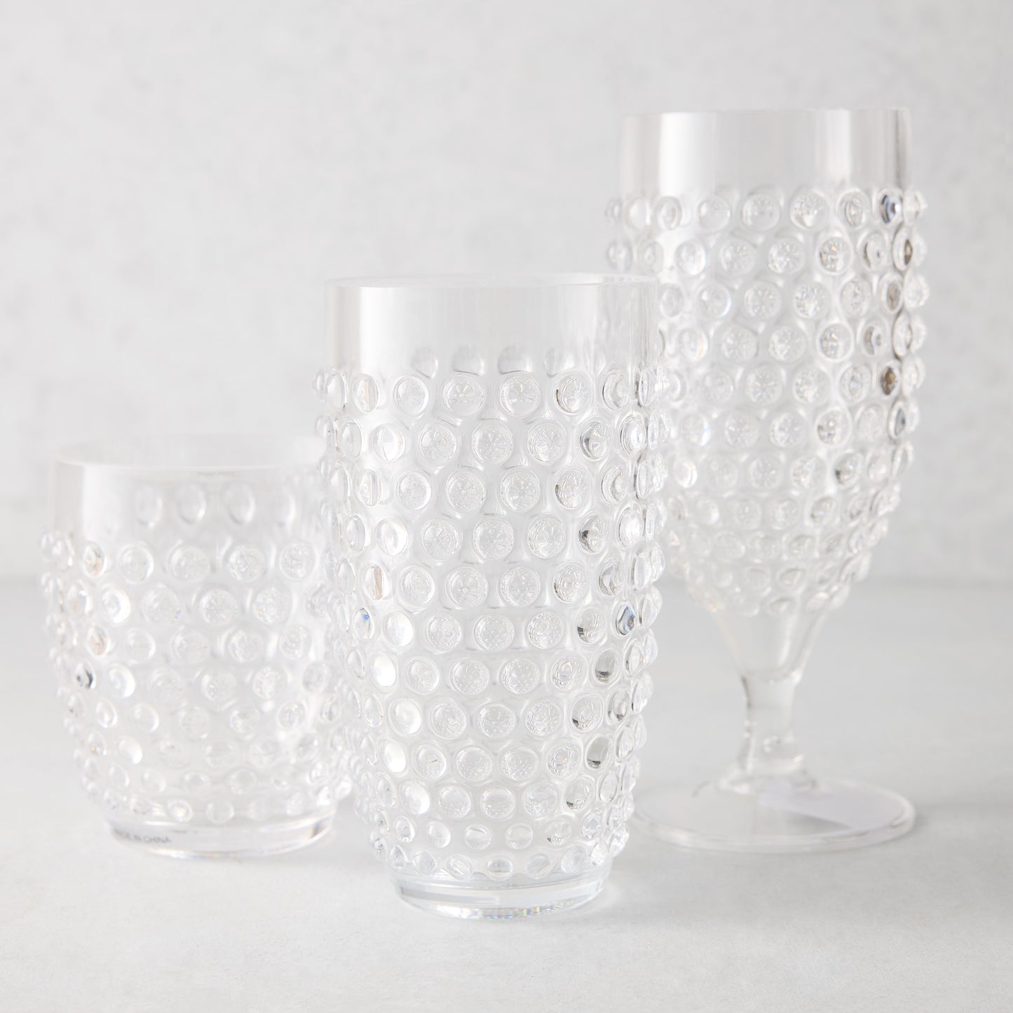 Clear acrylic bubble highball glass, tumbler, and wine glass set.