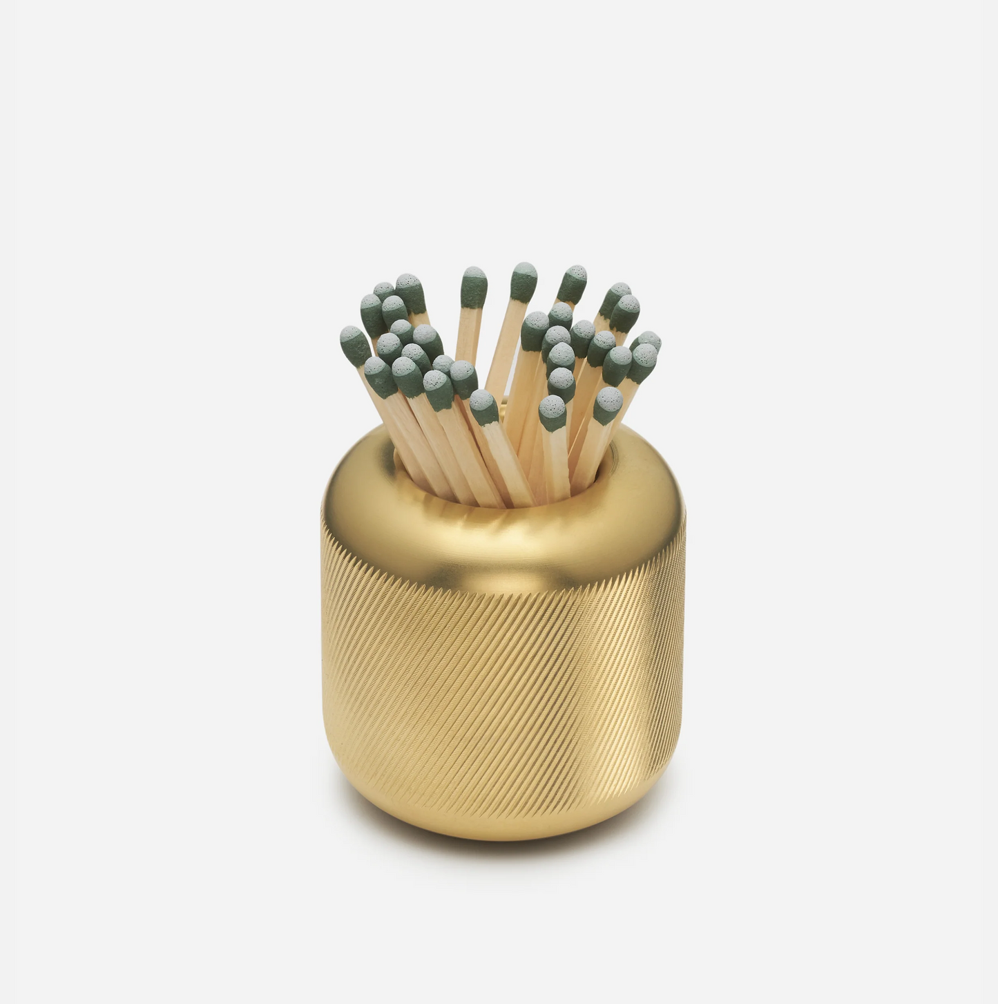 Solid brass match striker with deep knurling, holding matches with green tips.