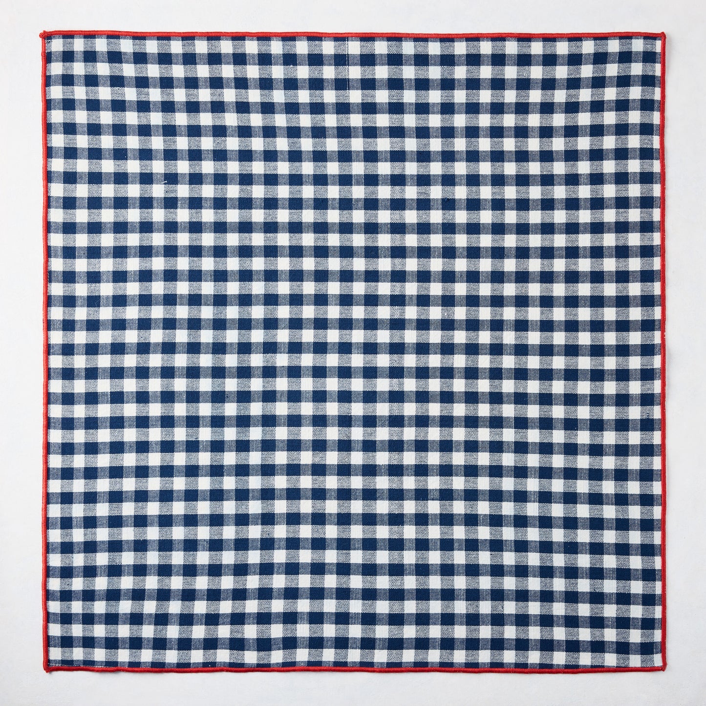 Chatham Navy Blue Gingham Cotton Napkin, 22" square, with red embroidered trim.