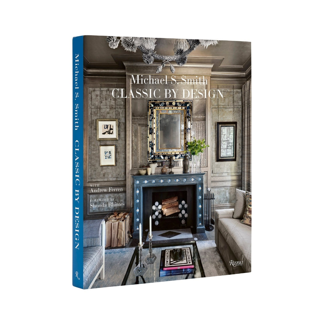 Hardcover book "Classic by Design" by Michael S. Smith, featuring a dark gray interior design photo on the cover.