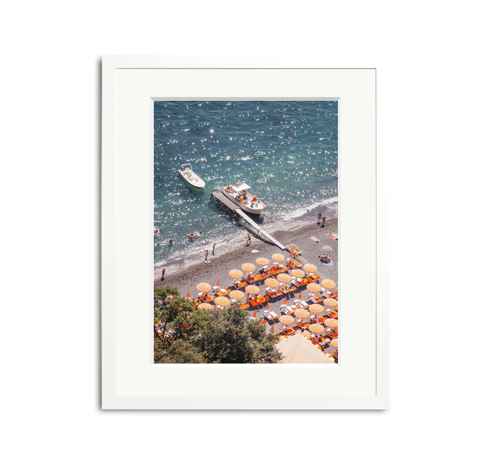 D'Arienzo II framed wall art print of a vibrant Italian beach with orange striped umbrellas and boats.