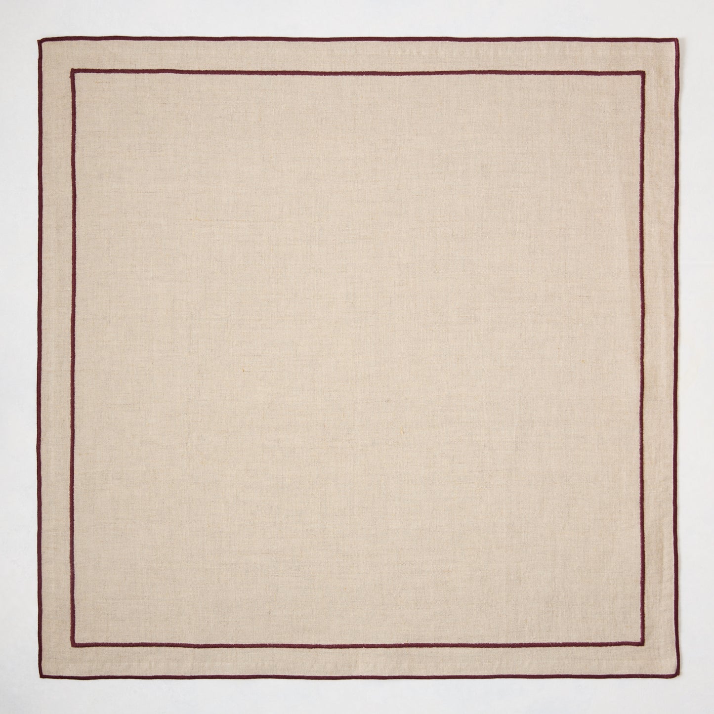 Beige natural cotton napkin with dark plum double-line embroidered border.