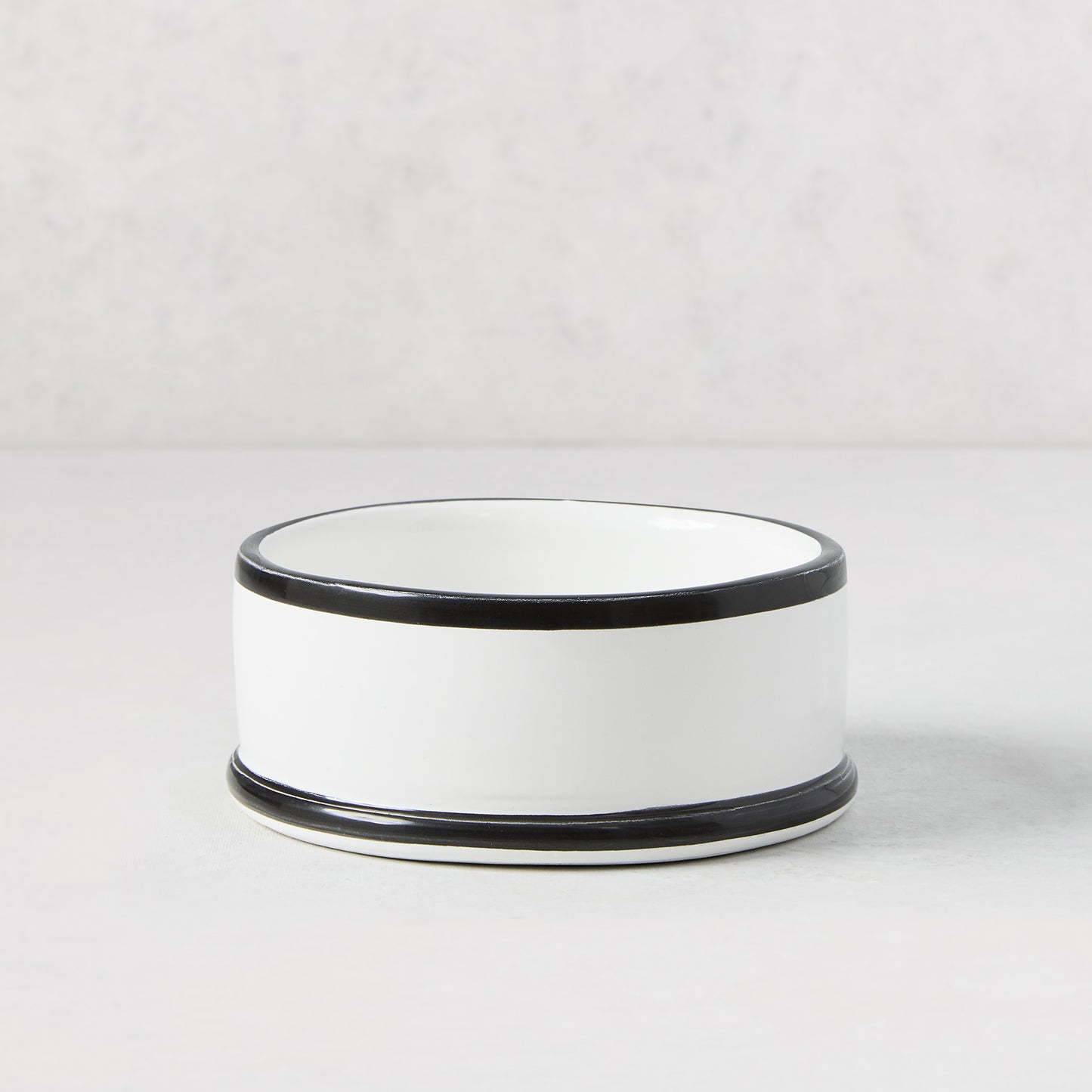 Diane Keaton + Hudson Grace white ceramic wine coaster with hand-painted black lines.