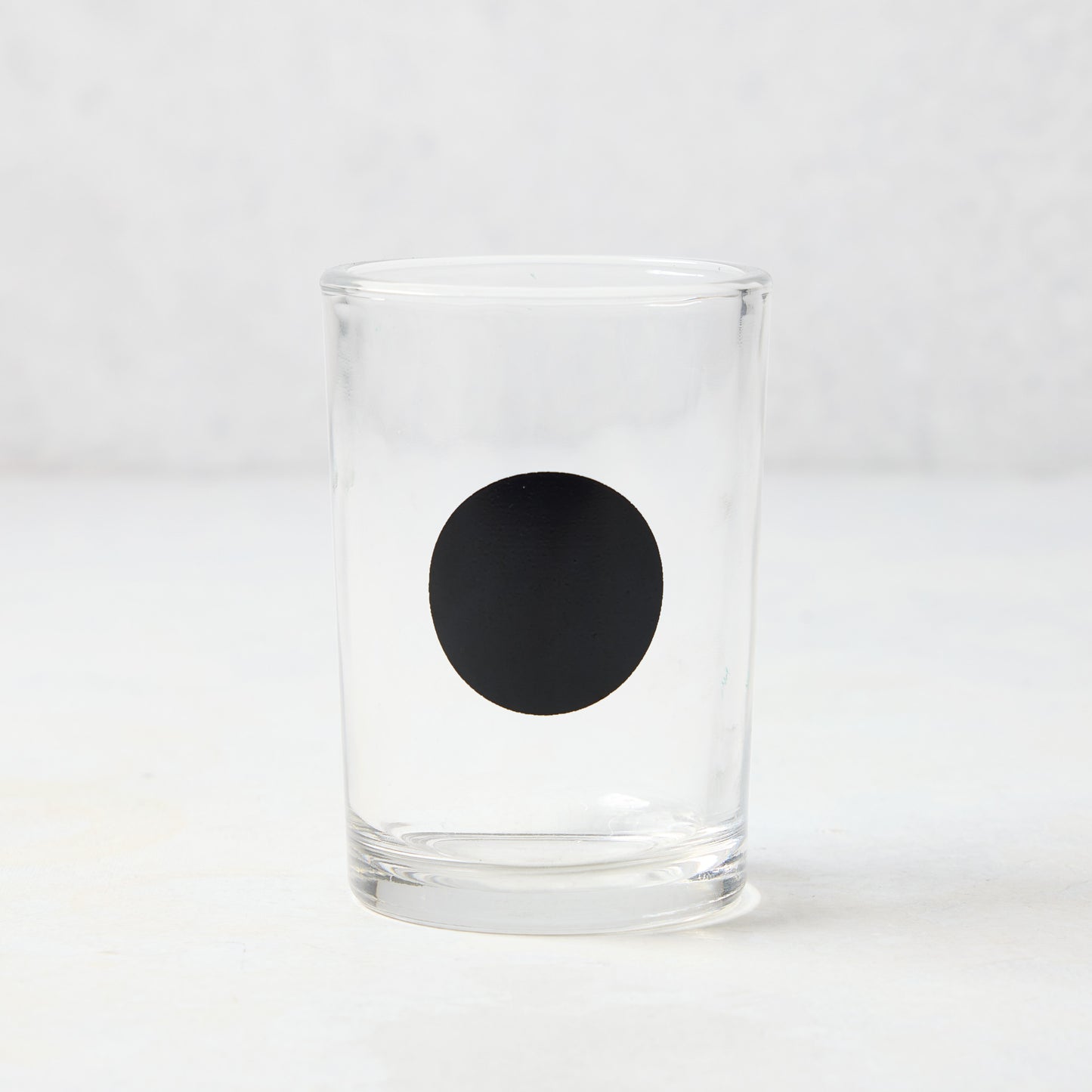 Diane Keaton + Hudson Grace clear glass everyday wine glass with a bold black dot.