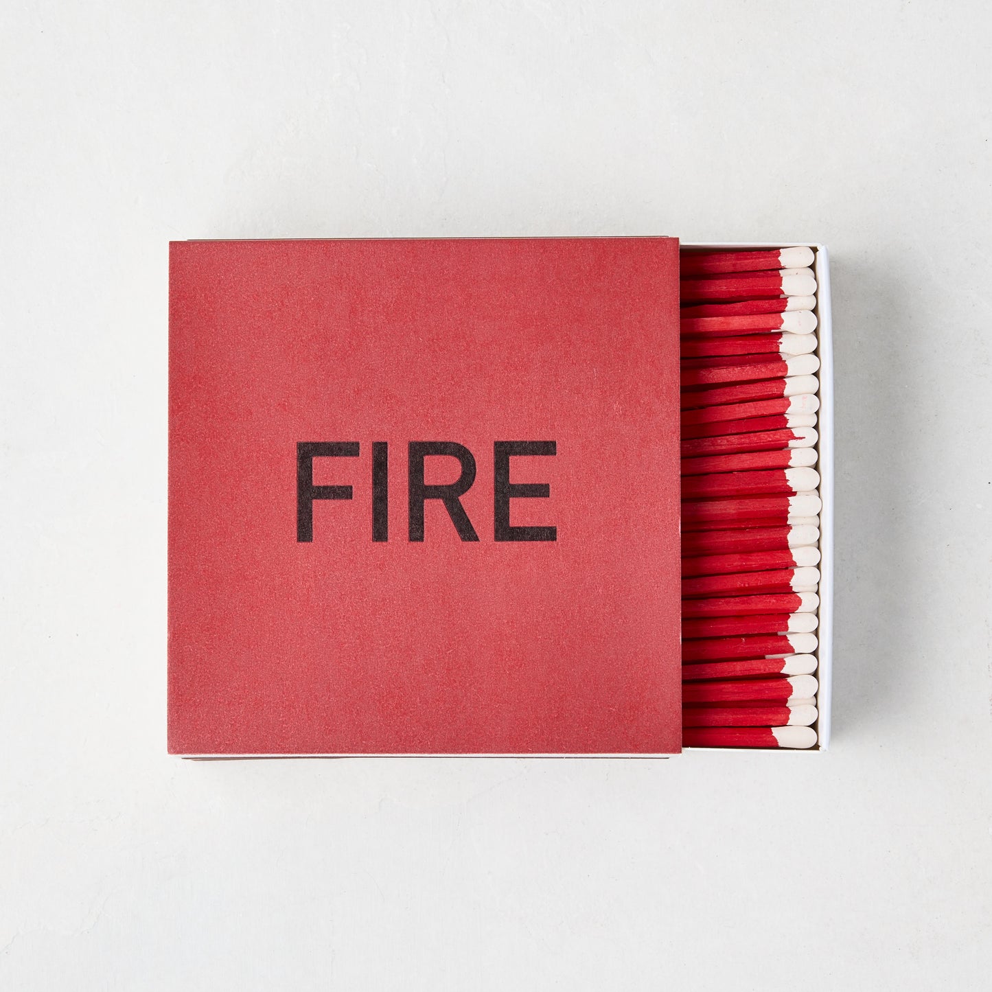 Diane Keaton x Hudson Grace "Fire" oversized boxed matches, red box with "FIRE" in black, red 4-inch matches visible.