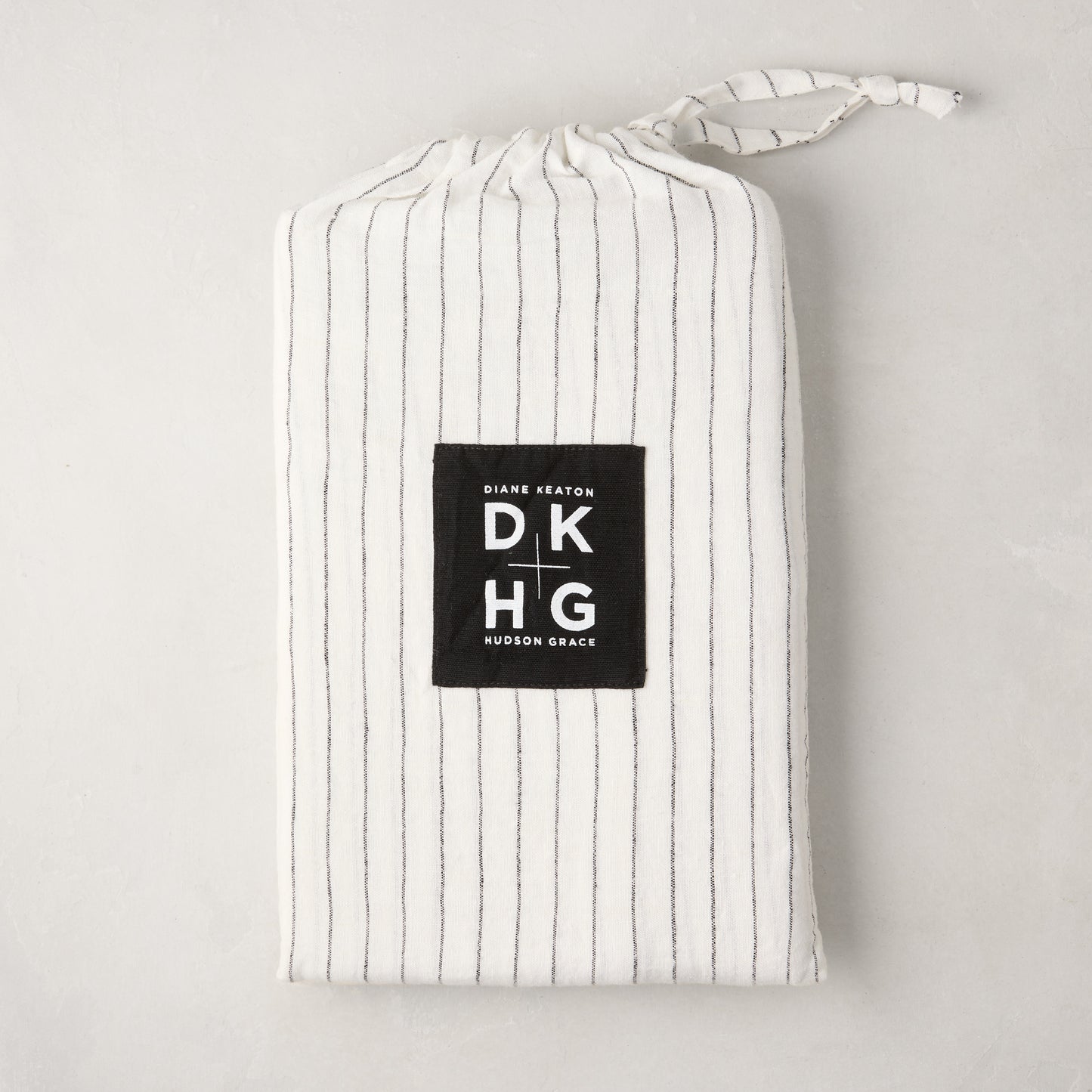 Diane Keaton x Hudson Grace Shirting Stripe Linen Shams, set of 2, in a white and black striped linen bag.