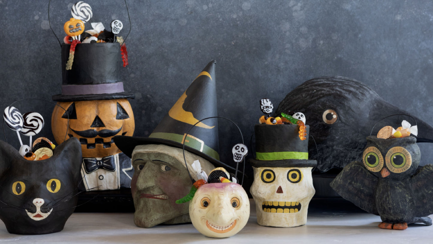 Hand-painted papier-mâché Halloween candy buckets: black cat, pumpkin, witch, skull, owl, and crow.