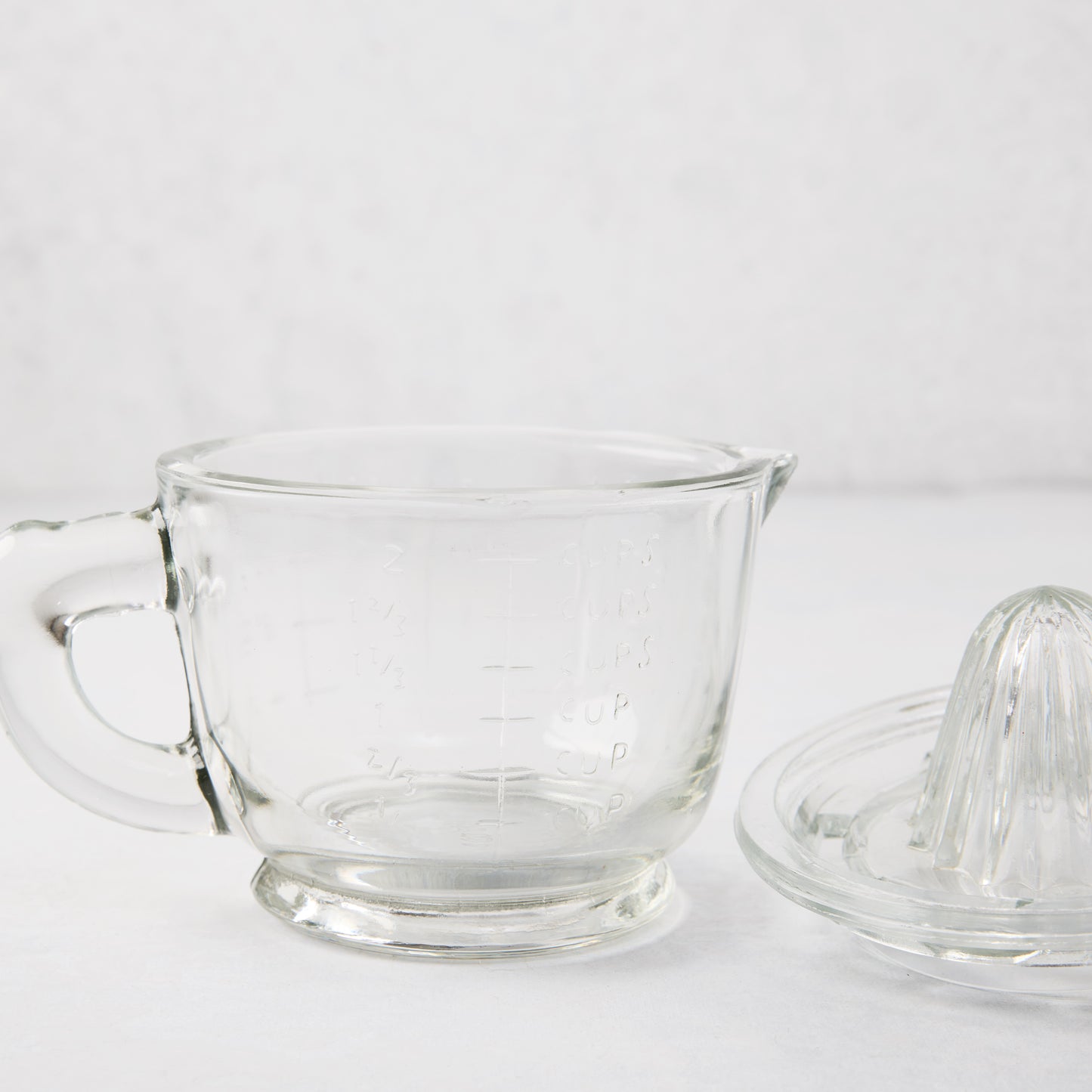 Clear recycled glass juicer/pitcher with handle, spout, engraved measurements, and separate reamer lid.