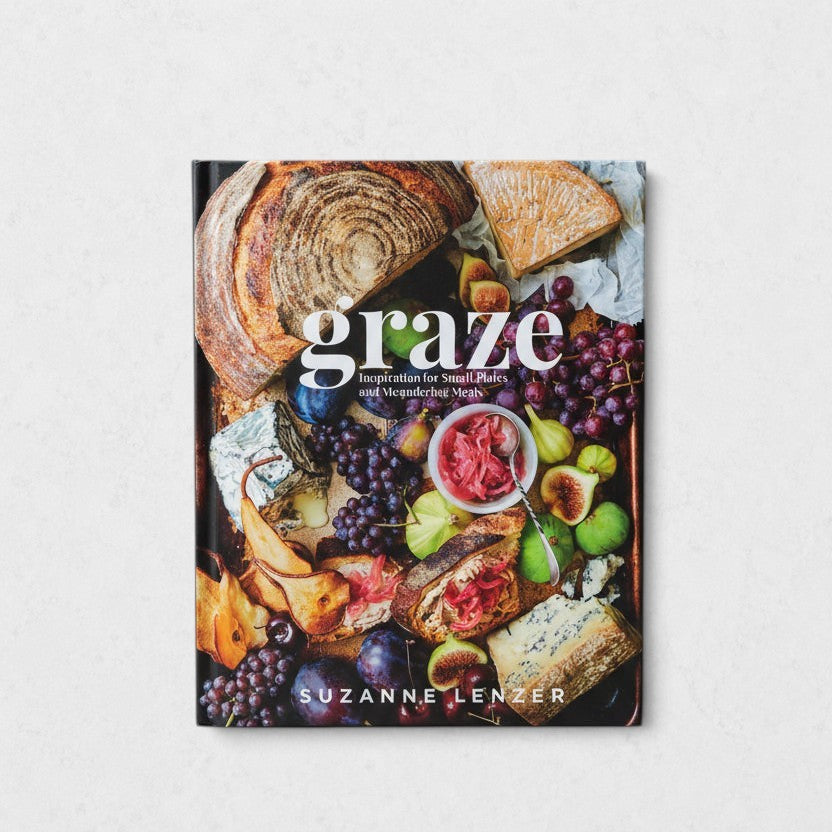 Hardcover "Graze" coffee table book with a colorful cover featuring bread, cheese, fruit, and small plates.