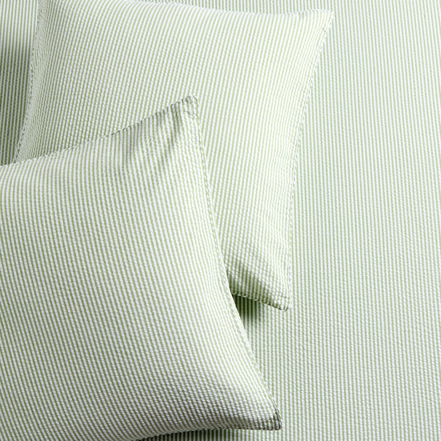 Set of 2 green seersucker stripe organic cotton Euro shams with envelope closures.