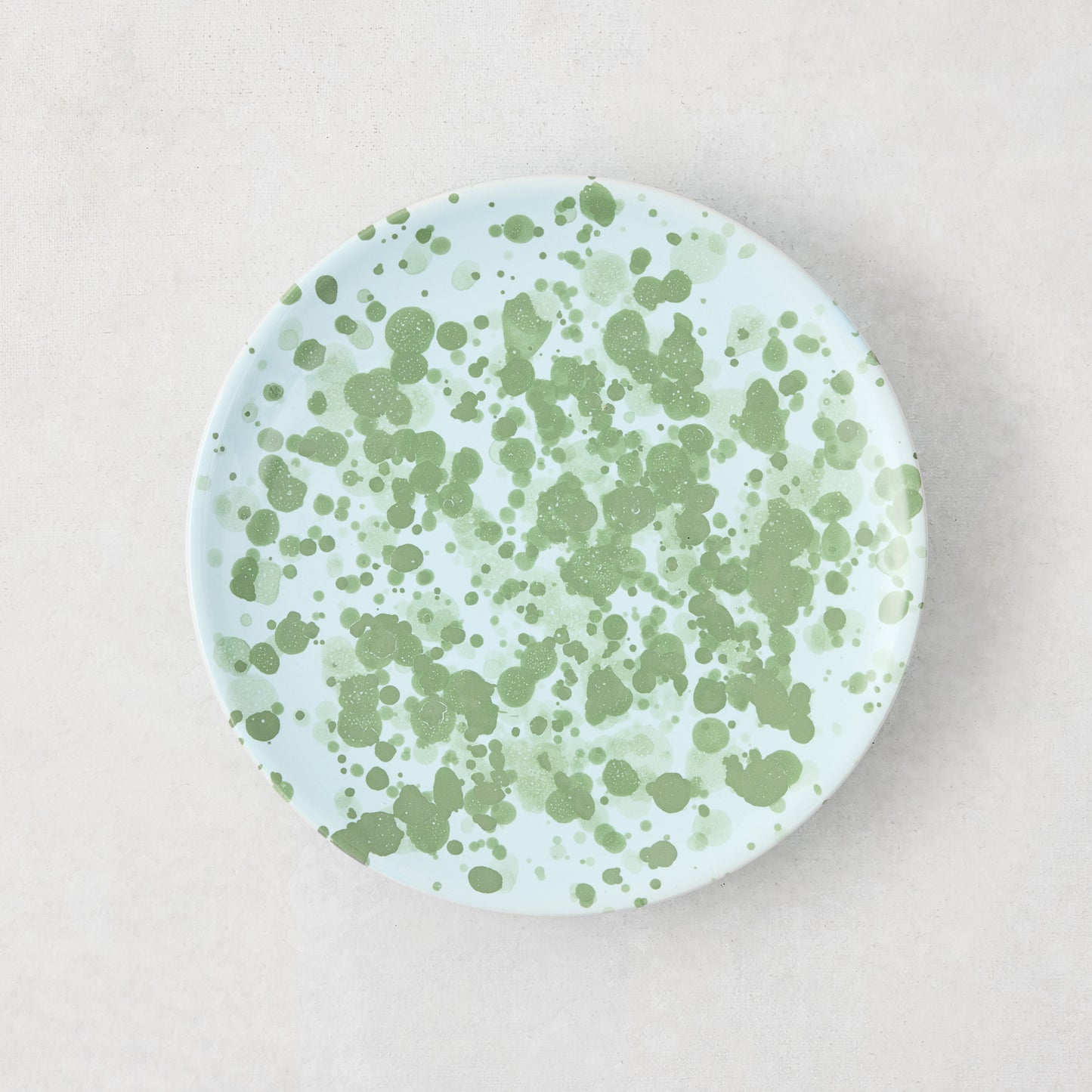 Hand-painted Italian stoneware appetizer plate, 6.3"Dia, with pale blue glaze and green splatter pattern.