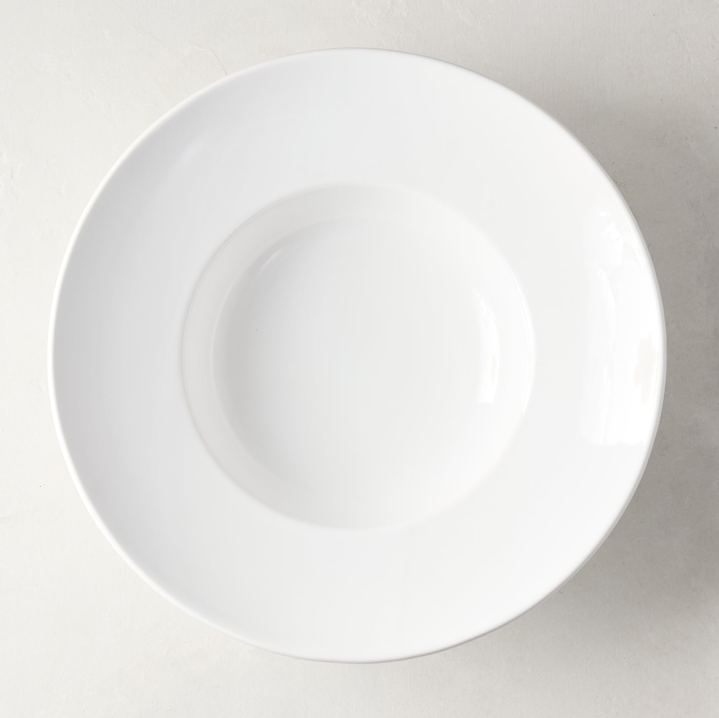 White ceramic wide-rim soup bowl, 9" diameter, top-down view.