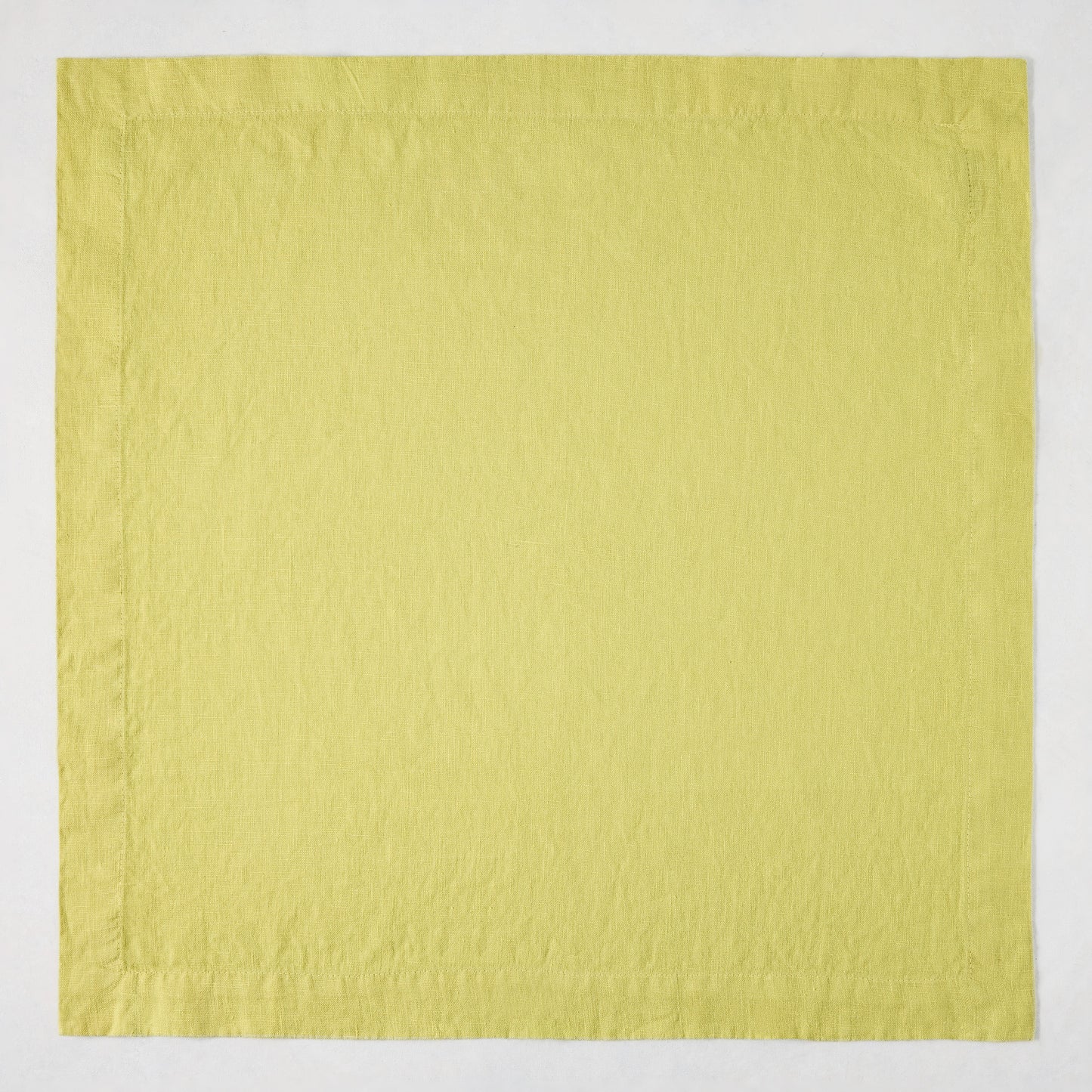 HG Sour Apple hand-dyed 22-inch square linen napkin with mitered corners.