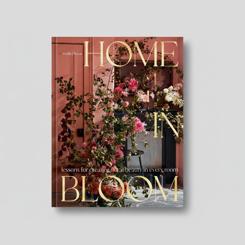 Hardcover "Home in Bloom" coffee table book with gold lettering and a floral interior design cover.