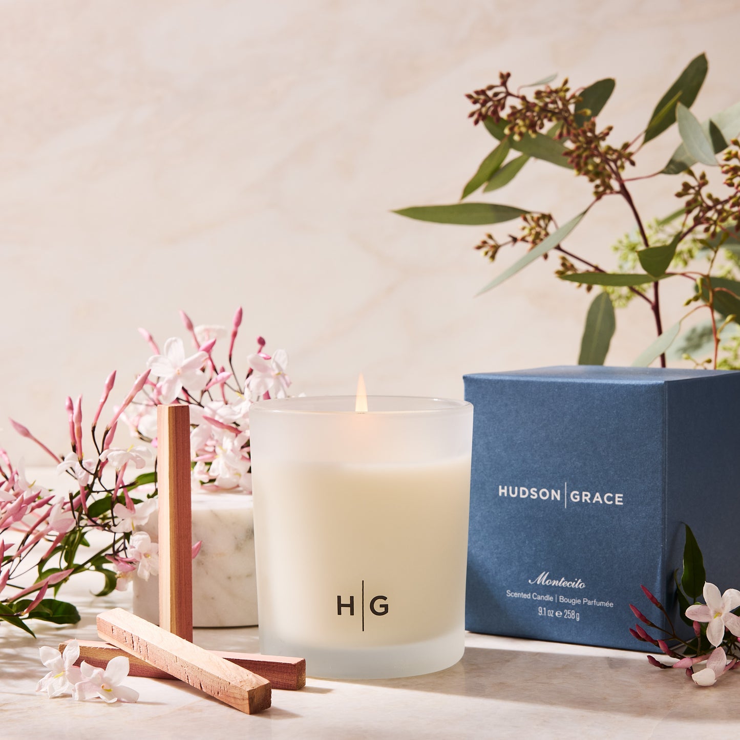 Hudson Grace Montecito scented candle in a frosted glass jar with a blue box, jasmine, and eucalyptus.