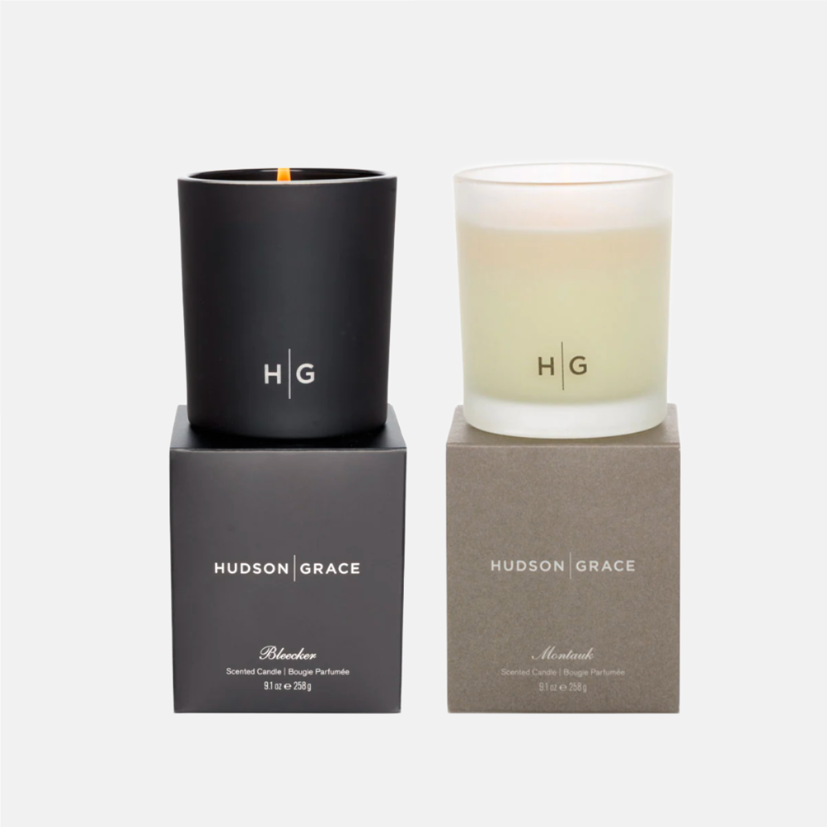 Hudson Grace New York Scented Candle Gift Set: a black Bleecker candle and a frosted Montauk candle in glass vessels.