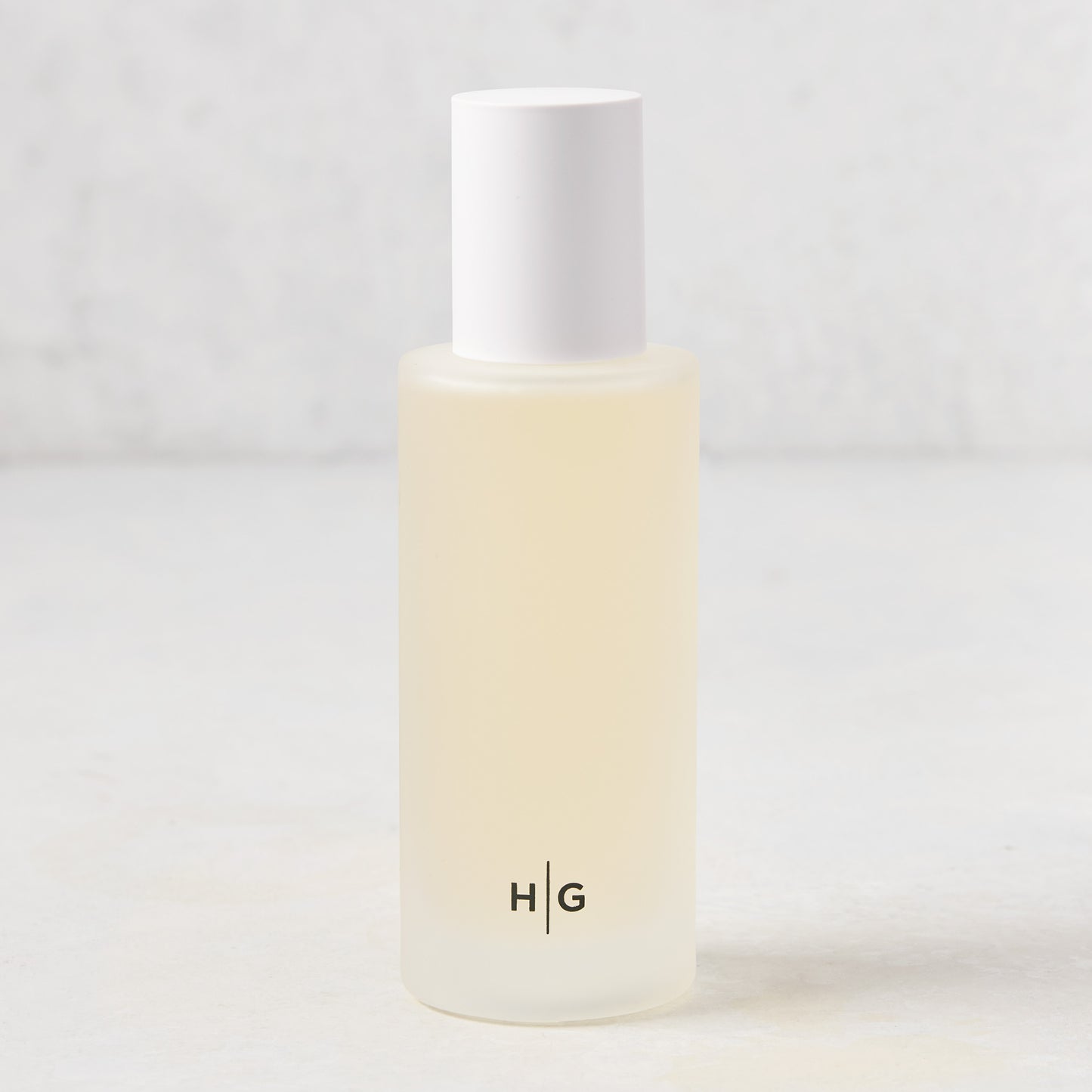 Hudson Grace Palm Beach Scented Room Spray in a frosted glass bottle with white cap and HG logo.