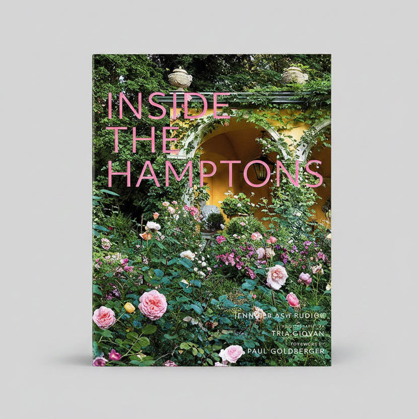 Inside the Hamptons" hardcover coffee table book with pink title over a lush garden scene.