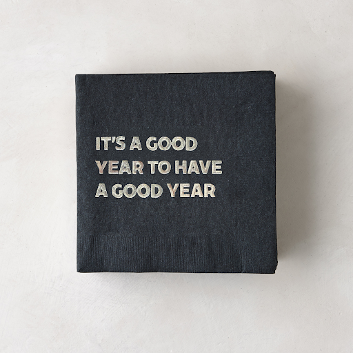 Black 5.5" square paper cocktail napkin with "It's a Good Year to Have a Good Year" in silver foil.