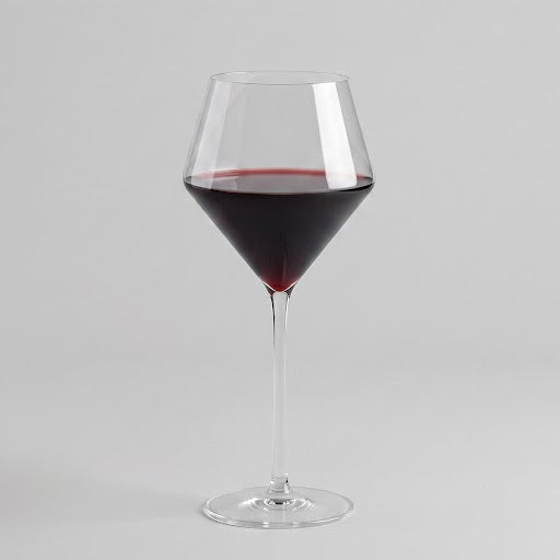 Modern Juniper red wine glass with a geometric bowl and thin stem, 17oz capacity, clear glass filled with red wine.