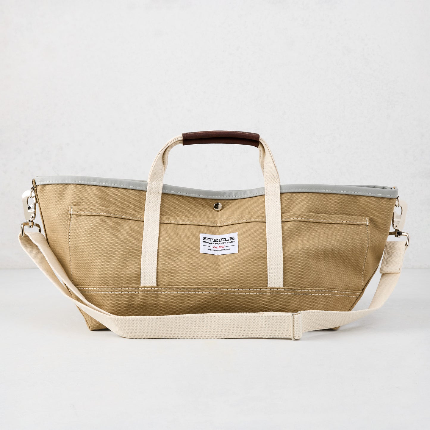 Khaki canvas garden tote bag with olive green exterior, grey interior, brown leather grips, and long shoulder strap.