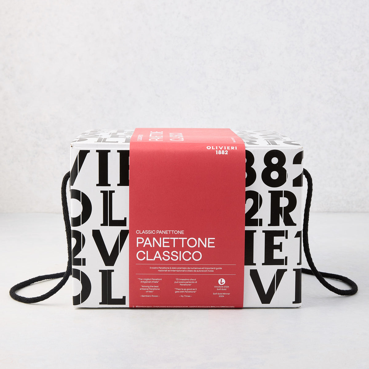 Large square box of Olivieri Classic Panettone with black typography, a red paper band, and black rope handles.