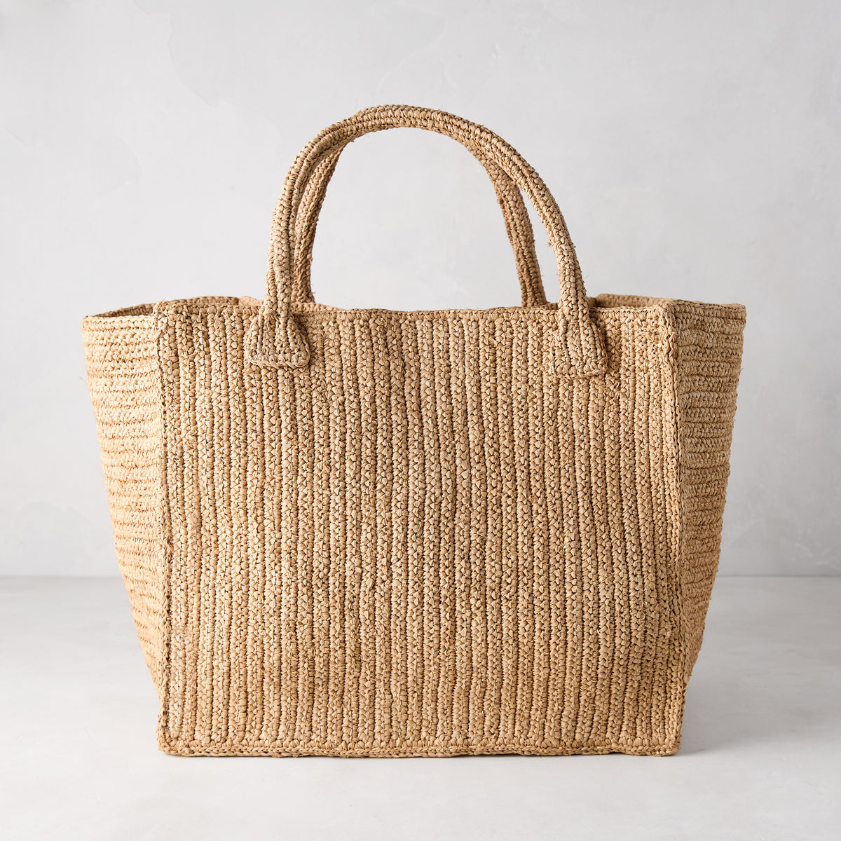 Madagascar Packable Raffia Tote Bag, natural tea-dyed, crocheted, with two top handles.