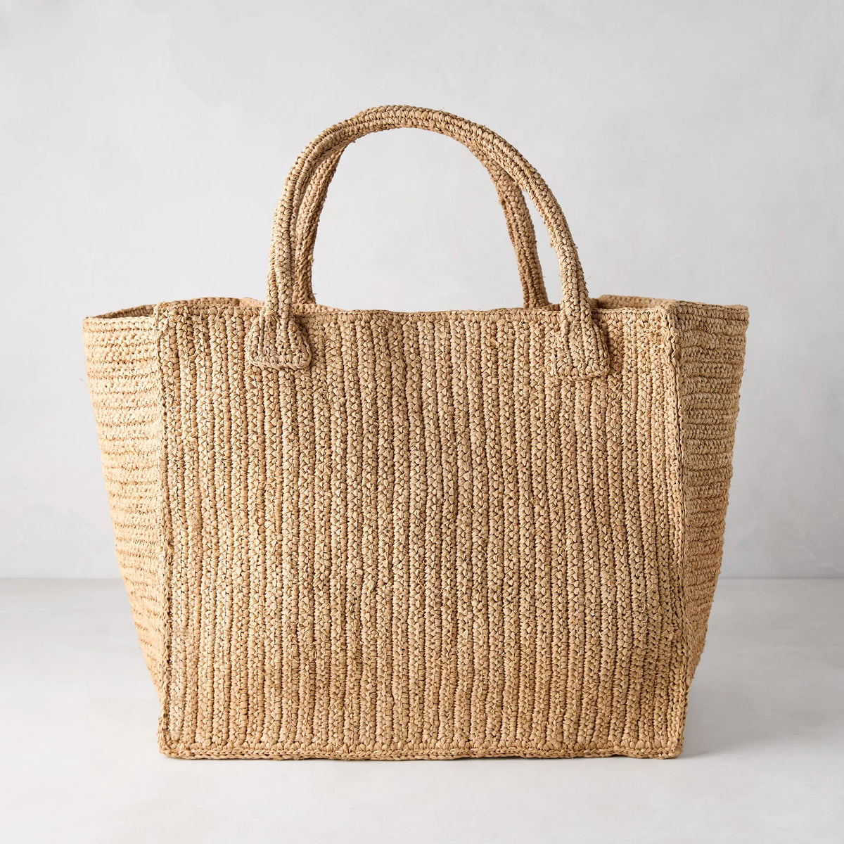 Madagascar Packable Raffia Tote Bag, natural tea-dyed, crocheted, with two top handles.