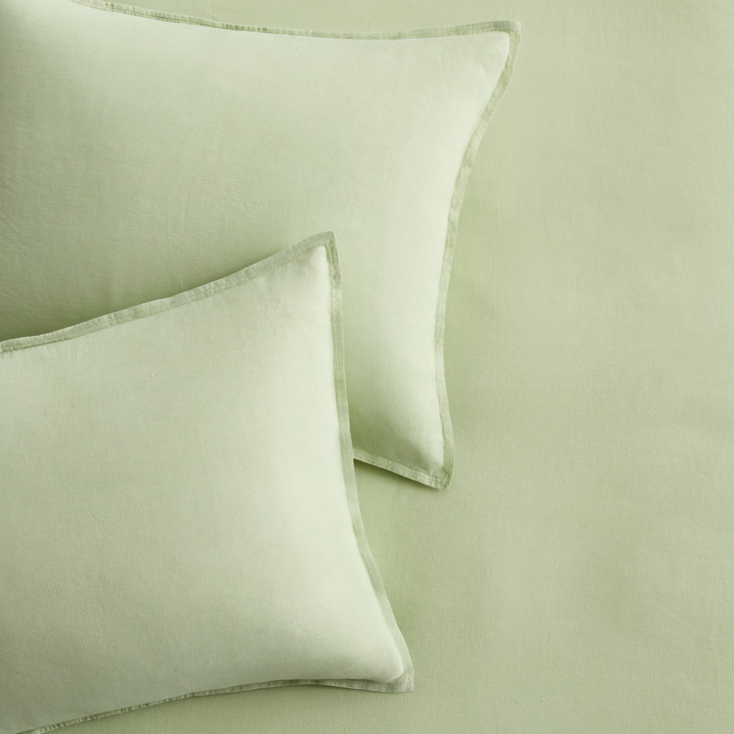 Set of two mint green European washed linen euro shams with a soft, textured finish and flange border detail.