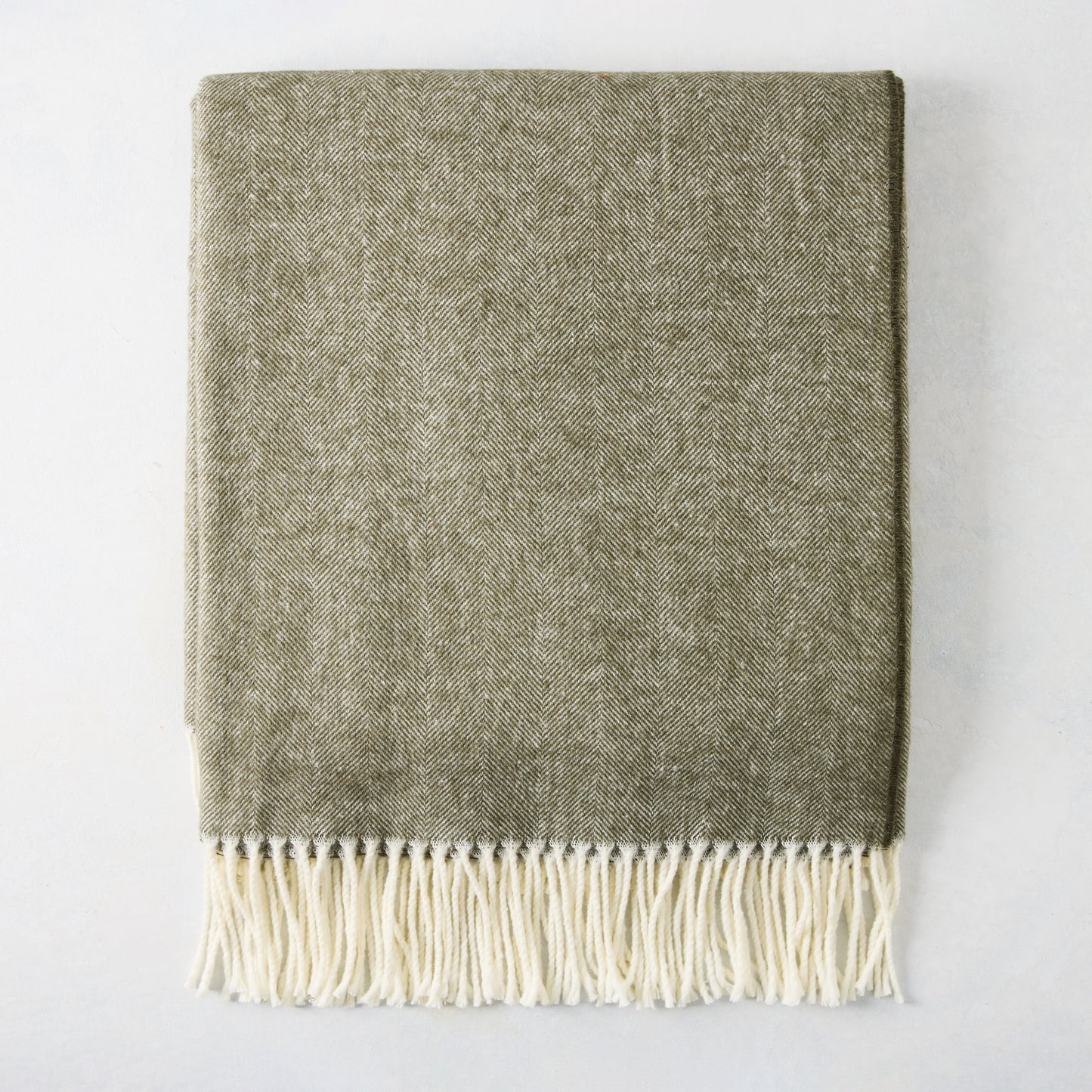 Moss Green Italian Herringbone Throw Blanket, 51"x67" cotton-acrylic blend with cream fringe.