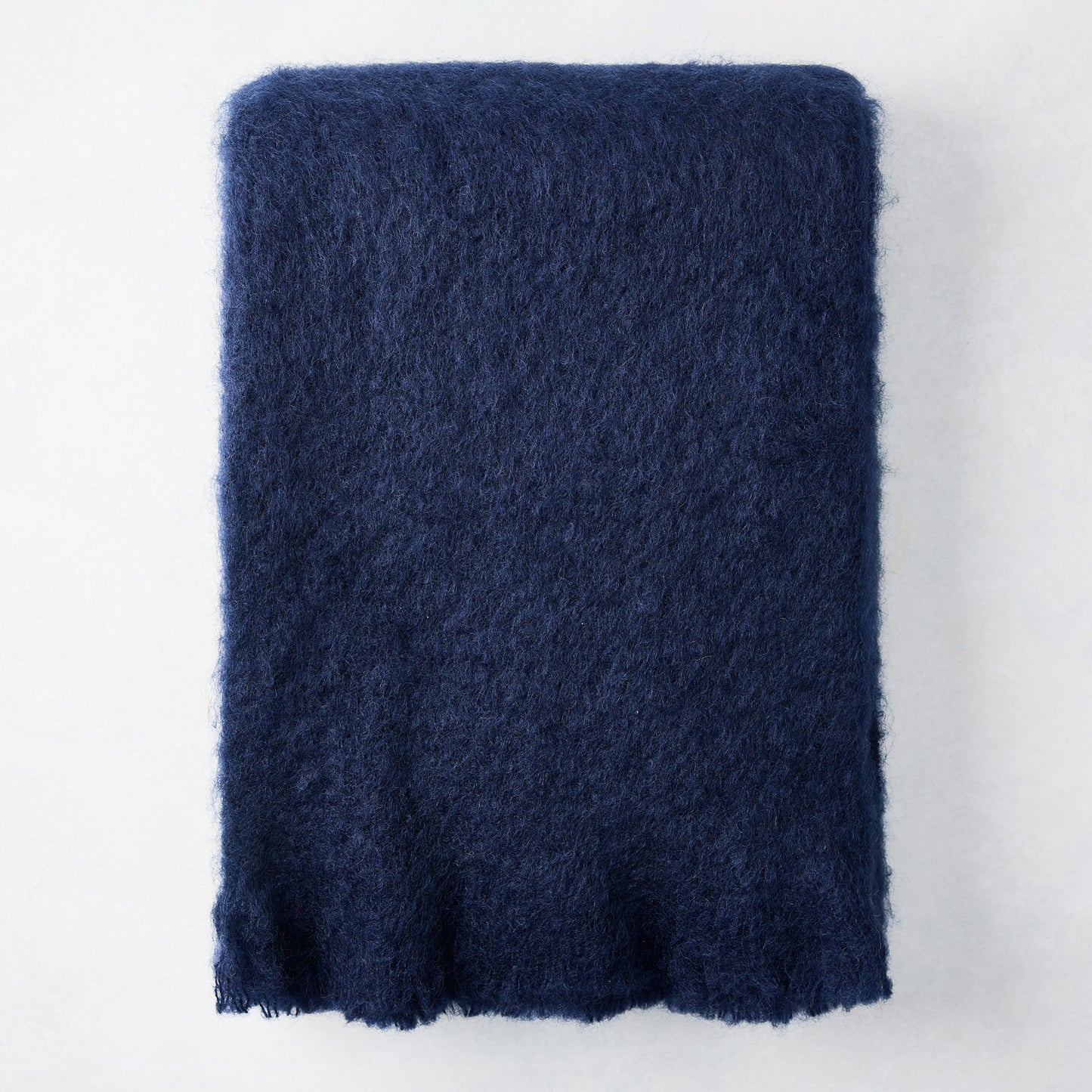 Navy blue mohair throw blanket, 72"L x 51"W, with a soft, fuzzy texture.