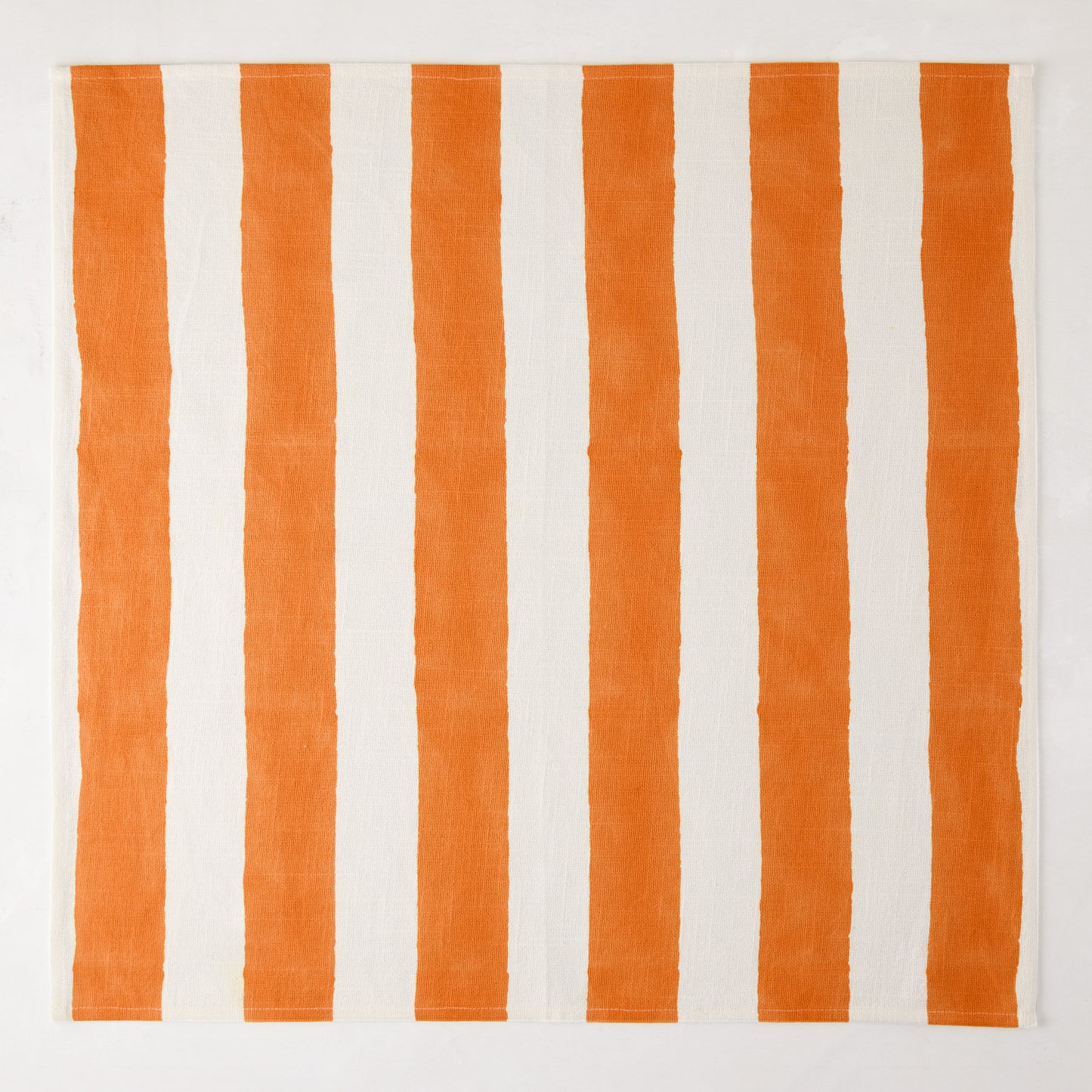 Orange Hampton Stripe Cotton Napkin, 22" square, with bold vertical orange and white stripes.
