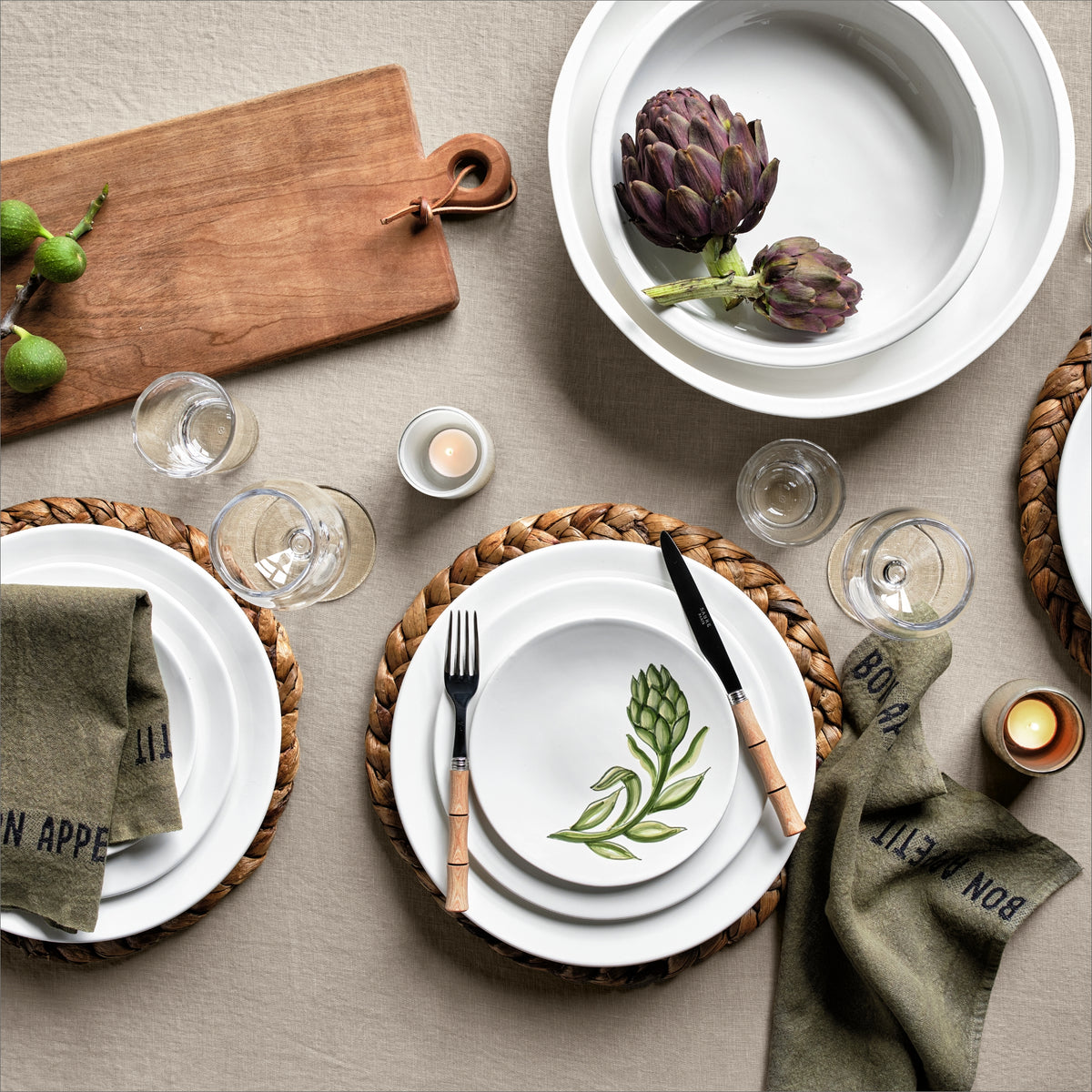 10-inch creamy white ceramic salad plate with clean edges, styled on a woven placemat with artichoke-themed dinnerware.