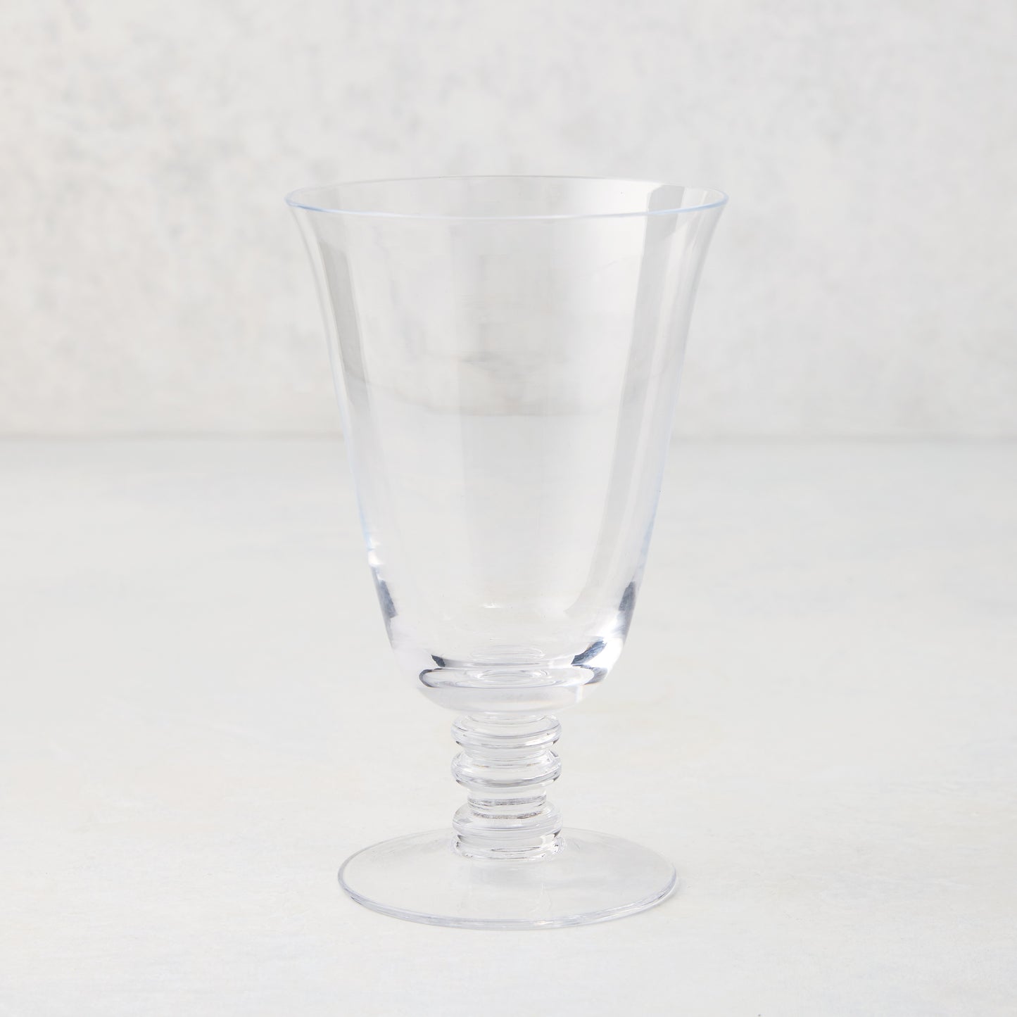 Palermo Stemmed Water Glass, clear hand-blown glass with curved lip and artistic ribbed stem.