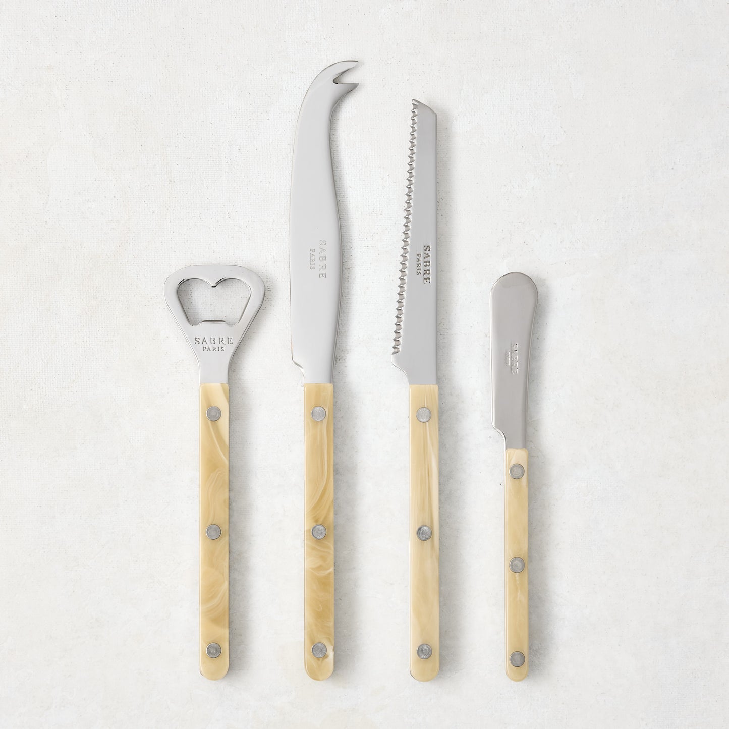 Paris Bistro Aperitif Set: 18/10 stainless steel bottle opener, tomato knife, cheese knife, butter spreader with cream acrylic handles.