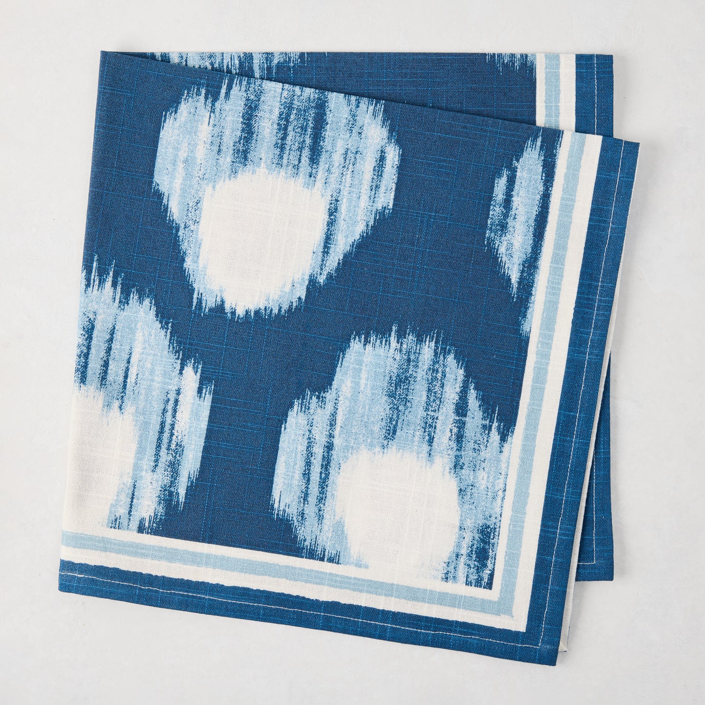 Peter Dunham + Hudson Grace Blue Bukhara Ikat Printed Napkin, 100% cotton slub, folded.