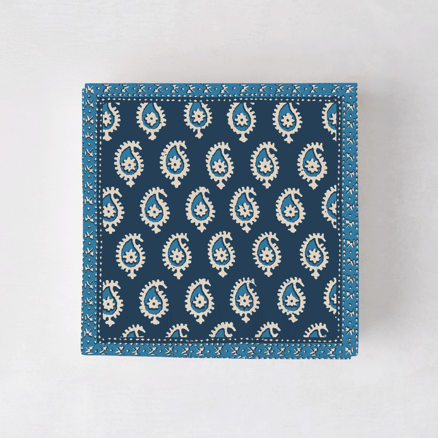 Peter Dunham + Hudson Grace Blue Janpath cocktail napkins with white paisley pattern.