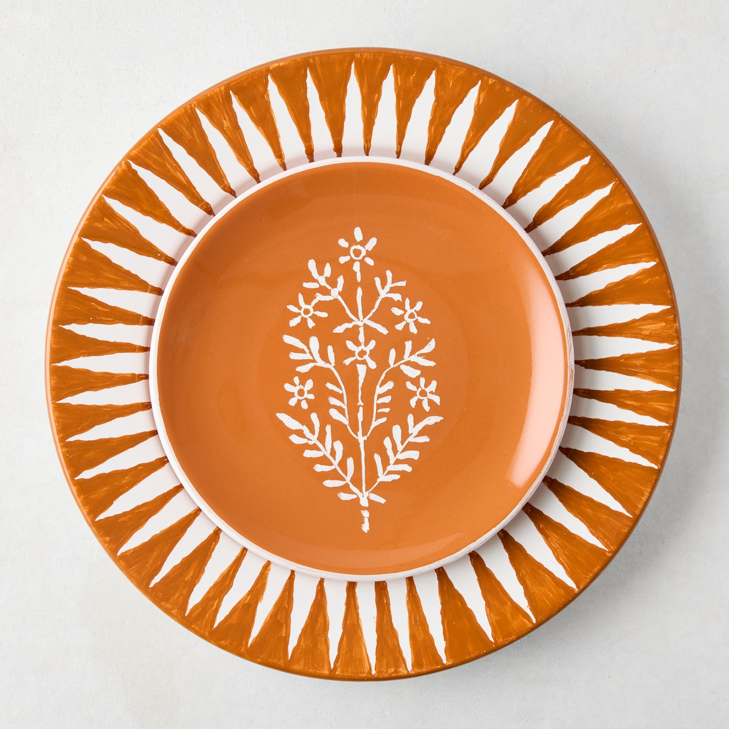 Peter Dunham + Hudson Grace Jaali Spice Orange appetizer plate with white floral pattern.