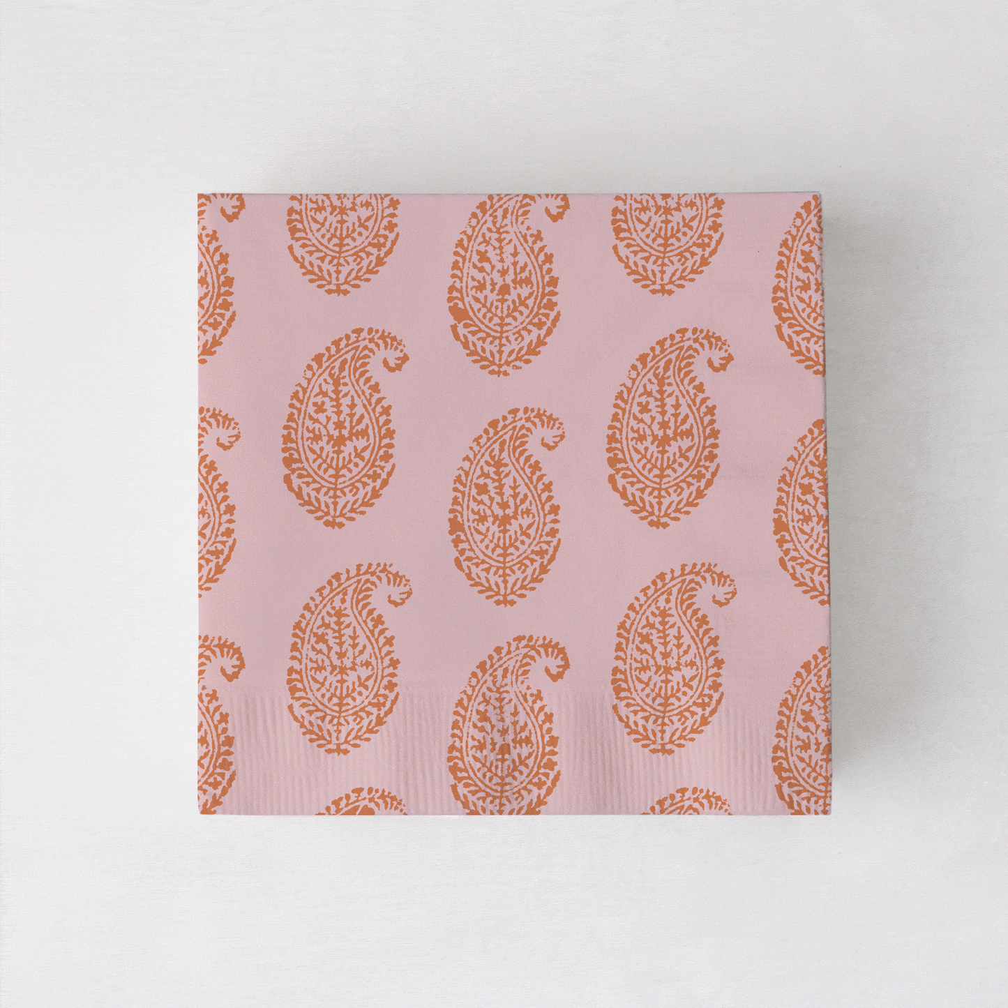 Peter Dunham + Hudson Grace Orange Kashmir cocktail napkins with paisley print.