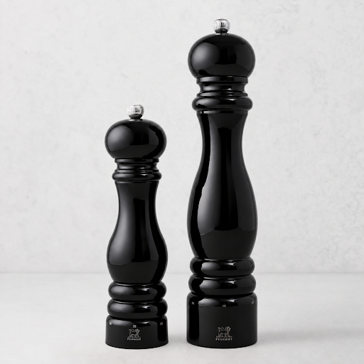 Peugeot Paris 9-inch salt and 12-inch pepper mills in glossy black lacquer finish with silver-tone metal knobs.
